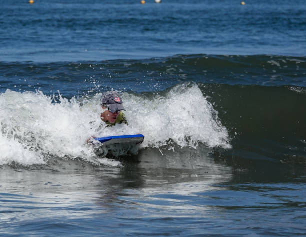 istock Active mature woman boogie boarding in Mexico. 1488874264