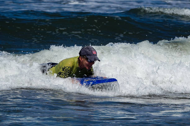 istock Active mature woman boogie boarding in Mexico. 1488874265