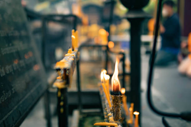 The burning of candles to worship sacred objects is the belief of Buddhists, Brahmins, and Hindus.