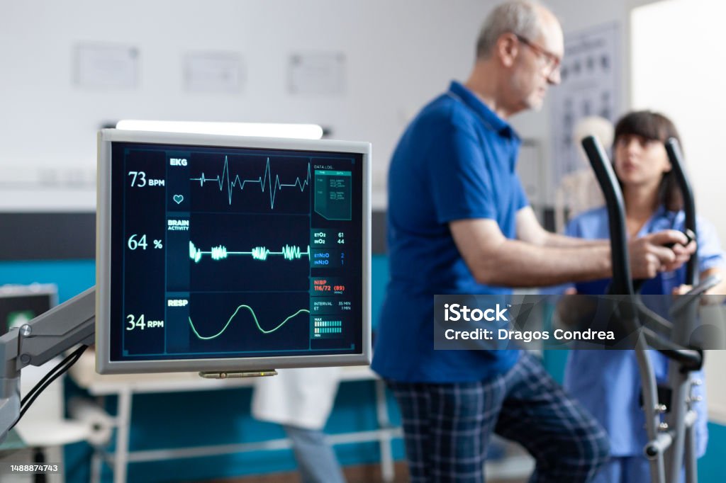 Close up of heart rate monitor measuring heartbeat Close up of heart rate monitor measuring heartbeat for patient doing gymnastics for physical recovery. Retired man using sport equipment to exercise for physiotherapy and strength. Heart - Internal Organ Stock Photo