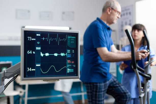 Close up of heart rate monitor measuring heartbeat Close up of heart rate monitor measuring heartbeat for patient doing gymnastics for physical recovery. Retired man using sport equipment to exercise for physiotherapy and strength. recovery stock pictures, royalty-free photos & images