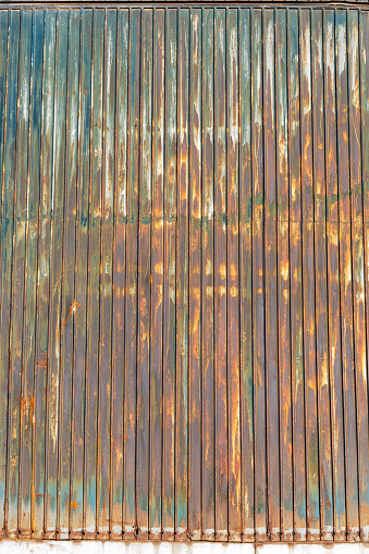Wall of a steel gray old rusty sea cargo container. Isolated with patch