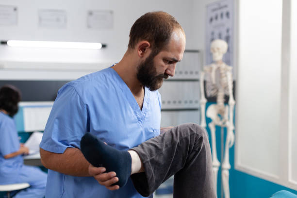 istock Close up of general practitioner helping retired woman 1488877323