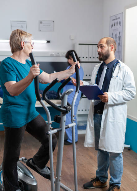 istock Doctor consulting elder patient doing gymnastics for recovery 1488877542