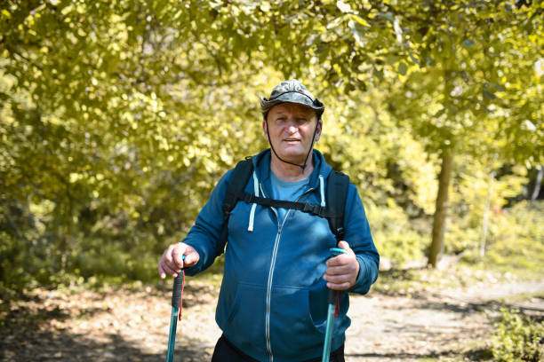istock Smiling Senior Hiker Stopping By A Meadow 1488877655