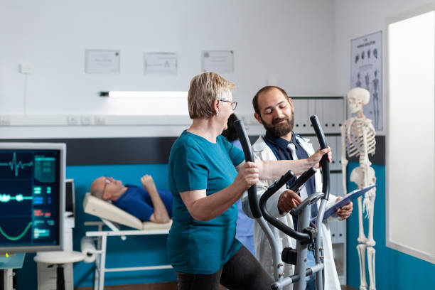 istock Doctor talking to old patient doing physical exercise to recover 1488877866