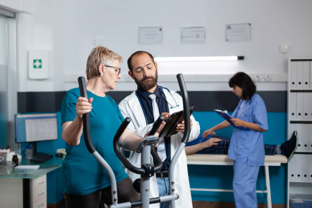 istock Doctor consulting old patient doing gymnastics for recovery 1488878053