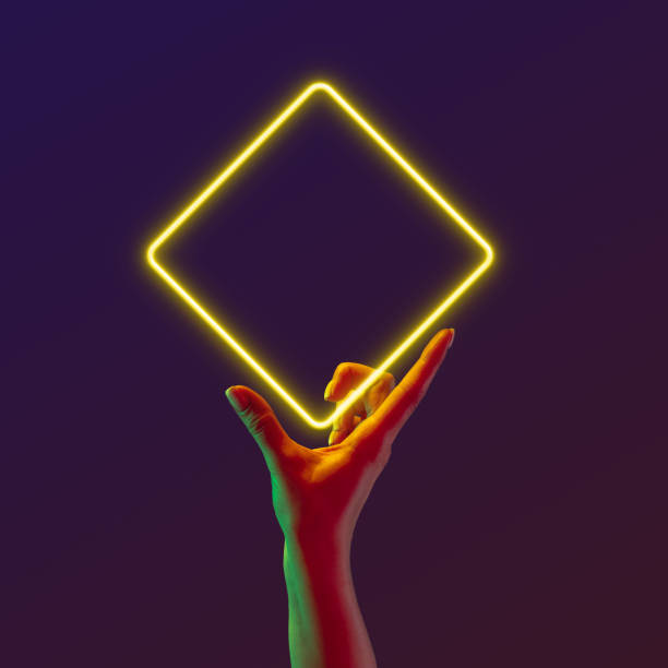istock Portrait with human hand holding neon frame, glowing square over abstract minimal violet background in neon light. Geometric figures 1488880027