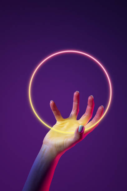 istock Portrait with human hand holding neon, glowing sphere over abstract minimal violet background in neon light. Virtual reality 1488880072