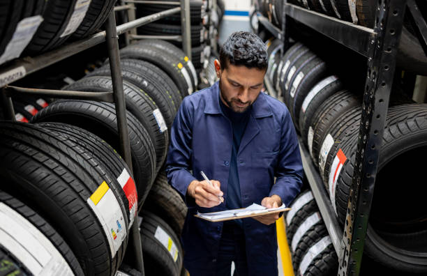 istock Man doing a stock inventory while working at a tire factory 1488880356