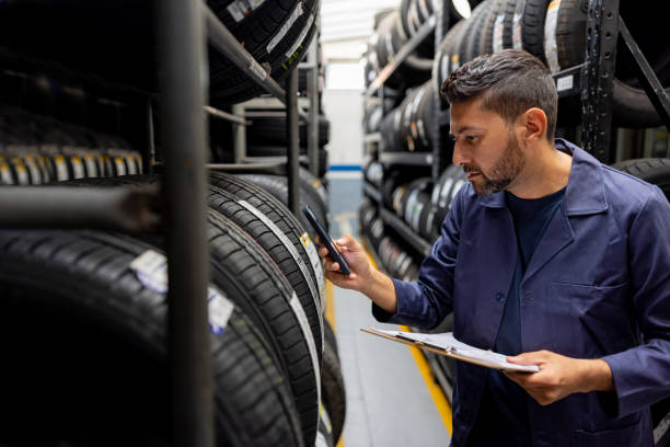istock Employee scanning a bar code on a tire at a garage shop 1488880427