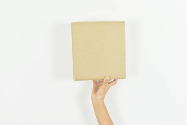 istock Woman hand holding cardboard box on white 1488880467