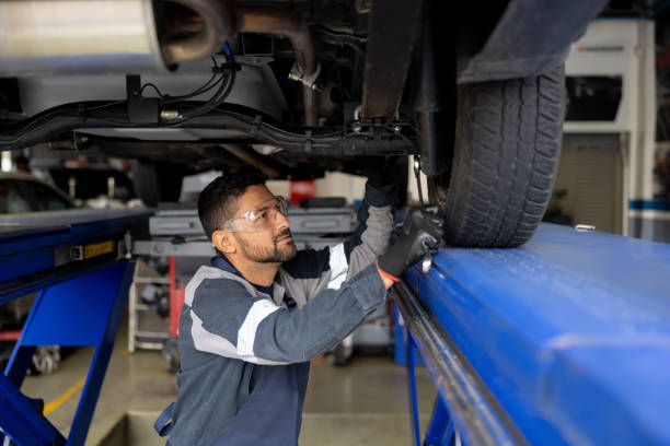 istock Mechanic working at a garage fixing a broker car 1488880493