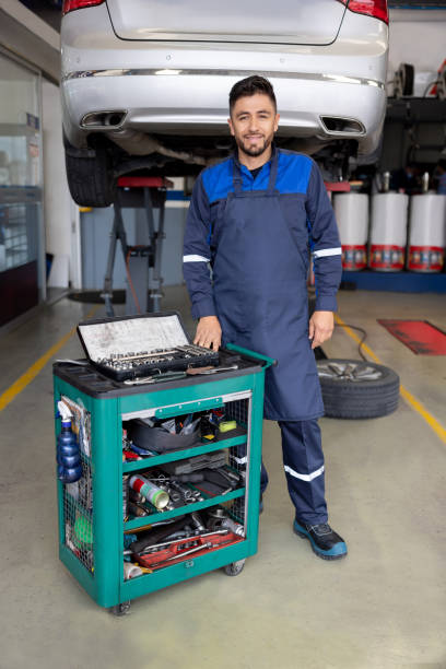 istock Happy mechanic working at a garage fixing cars 1488880708