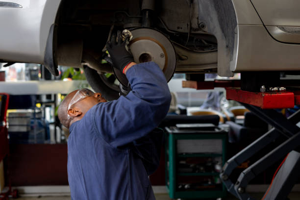 istock Mechanic aligning a car tire at a car garage 1488880728