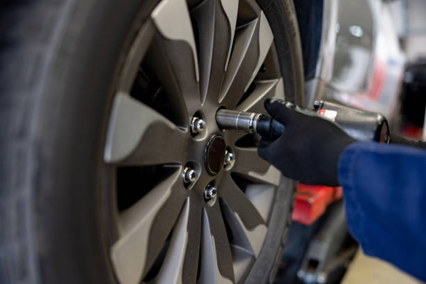 istock Close-up on a mechanic fixing a flat tire on a car 1488880779