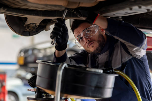 istock Mechanic working at an auto repair shop fixing a broken car 1488880806