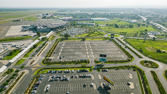 Aerial view of a bustling airport with a green lawn