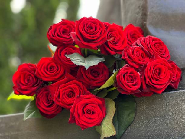 istock Bouquet of red roses on the monument. 1488881088