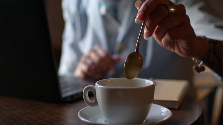 Stirring Up Coffee In A Café