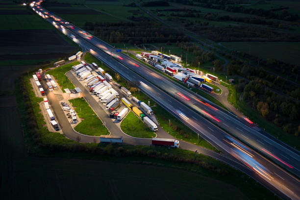 istock Highway and rest area at dusk - aerial view 1488884077