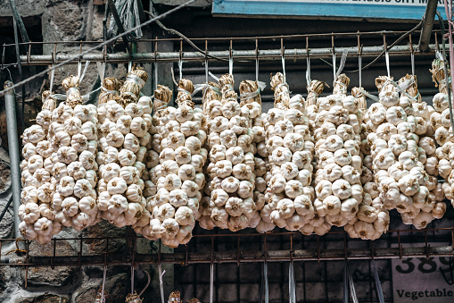 Garlic braid hanging for sale at farmers harvest days market