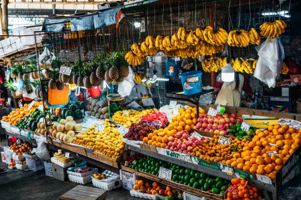 A colorful display of fresh fruits in a market stall in Baguio, Philippines, featuring various types of tropical produce. stock photo