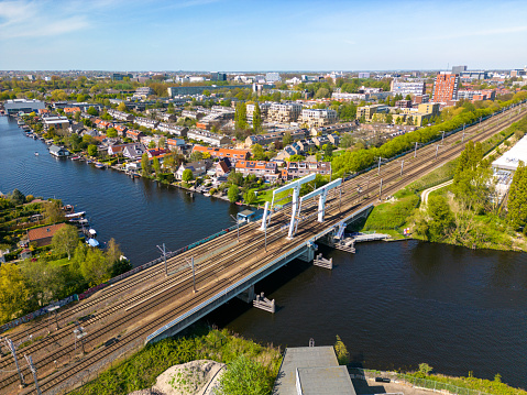 This aerial drone photo shows the railway Bridge in Leiden named Vinkbrug. The bridge goes over de Rijn, which is a river.