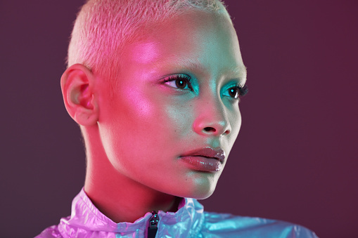 Vaporwave profile, black woman and cyberpunk cosmetics with model thinking in a studio. Isolated, glow makeup and futuristic cyber fashion of a young person with chrome clothing and scifi design