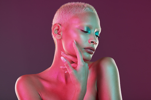 Neon, skincare and beauty, woman with hand in face, makeup and light in creative advertising on studio background. Cyberpunk, product placement and model isolated in futuristic skin care mockup space