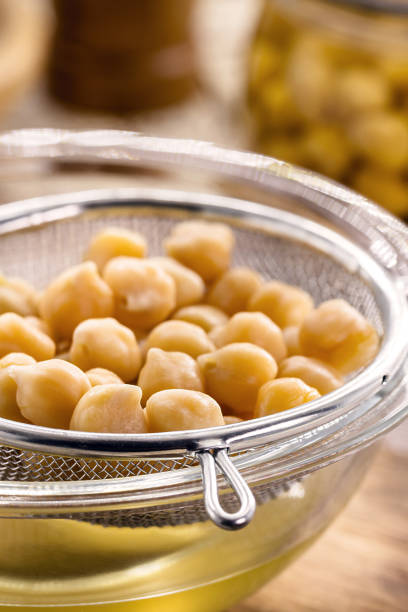 istock chickpeas being sieved to extract aquafaba, cooking liquid used as an alternative to egg whites 1488889867