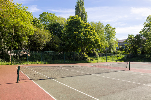 A tennis court in a public park in Newcastle upon Tyne, England. There is no one playing on it.