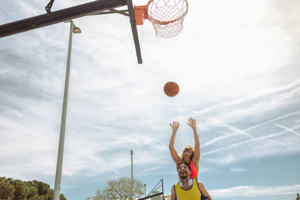 istock Young woman shooting a basketball 1488893994