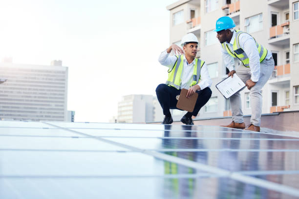 istock Solar energy, sustainability and engineer team on a rooftop to repair, program or install renewable power in a city. Sustainable, man and teamwork by technician for eco friendly electricity 1488894269