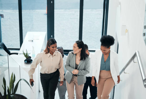 istock Conversation, office building or business people walking on steps while talking or in communication together. Company team, top or happy friends enjoy speaking in group discussion on break on stairs 1488894353