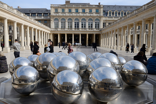 Paris, France - March 16, 2023: Big balls of plated color at Courtyard in the Royal Palace gardens of Paris, France.