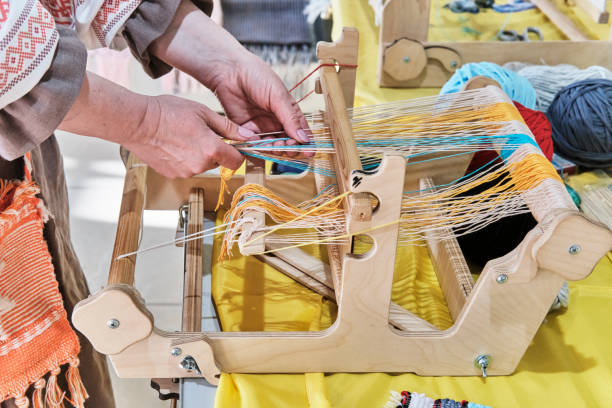 Female hands threading colorful warp threads on table loom. Female hands threading colorful warp threads on table loom. Craft concept hobbyist stock pictures, royalty-free photos & images