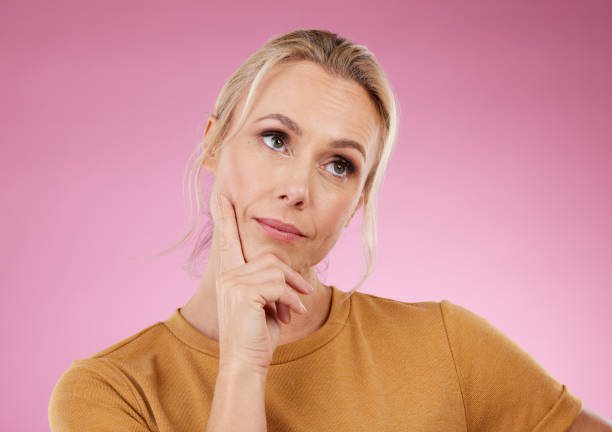 istock Thinking, woman and ideas on pink background, studio and color backdrop for mindset, planning or mockup. Inspiration, brainstorming and female model curious for question, solution and remember memory 1488895956