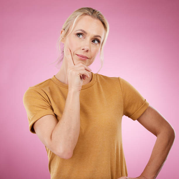 Old woman, thinking and confusion with ideas, opportunity and wellness on studio background. Female senior citizen, mature lady and thoughts for future, fantasy or wonder with imagination or creative