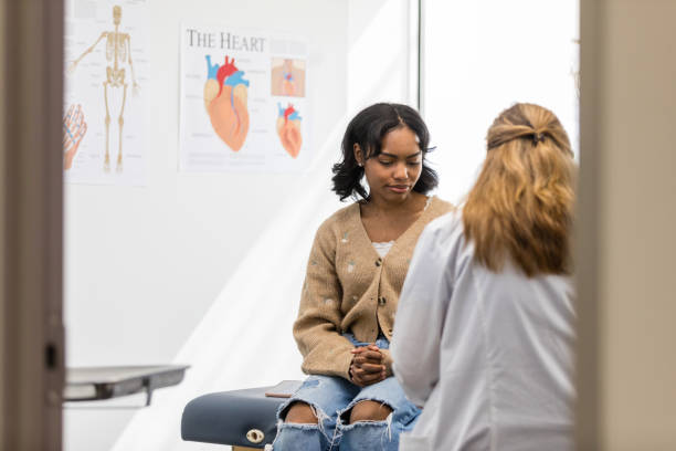 istock Young female student watches unrecognizable doctor write in medical record 1488897276