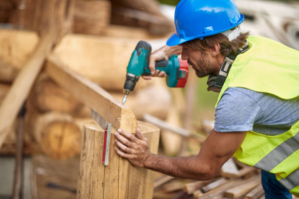 Young Man working with drilling machine on wooden construction.carpenter working