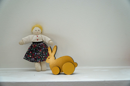 Cute little girl and a wooden rabbit