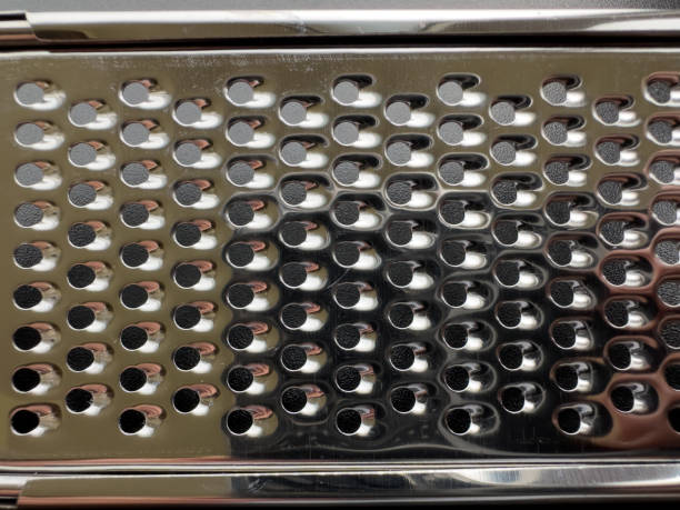 metal grater for vegetables on a white isolated background