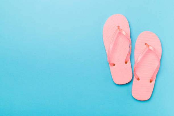 istock Bright flip flops on color background, top view 1488902417