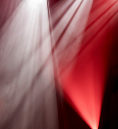 Abstract background of red and white light of stage from spotlights projectors, glow backdrop