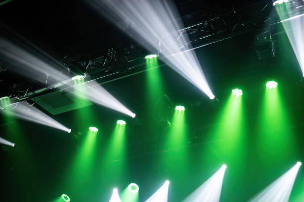 istock Light of stage with green and white spotlights 1488903028