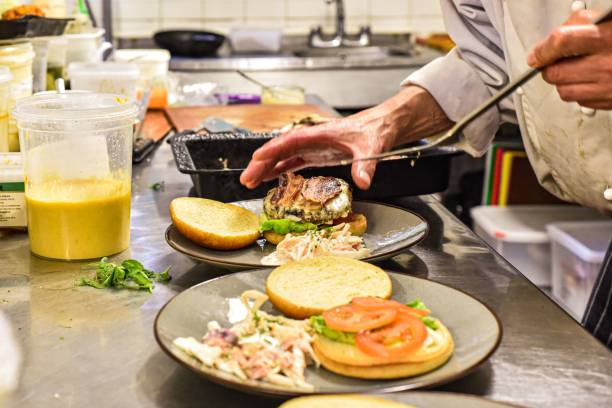 istock a cook prepares food at a restaurant counter while preparing a burger 1488903468