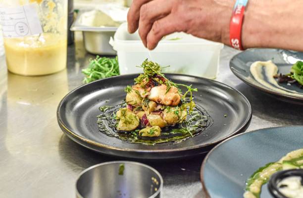 istock Professional chef hard at work in a commercial kitchen, preparing a delicious meal 1488903472