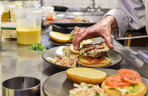 istock Chef preparing a fresh, homemade hamburger meal 1488903496