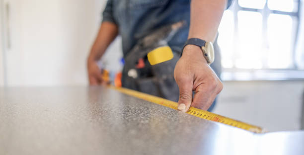 istock Carpenter, work table and measure tape with hands, design diy and home improvement for building, wood or job. Builder, construction worker and handyman by countertop, planning and vision in workplace 1488903524